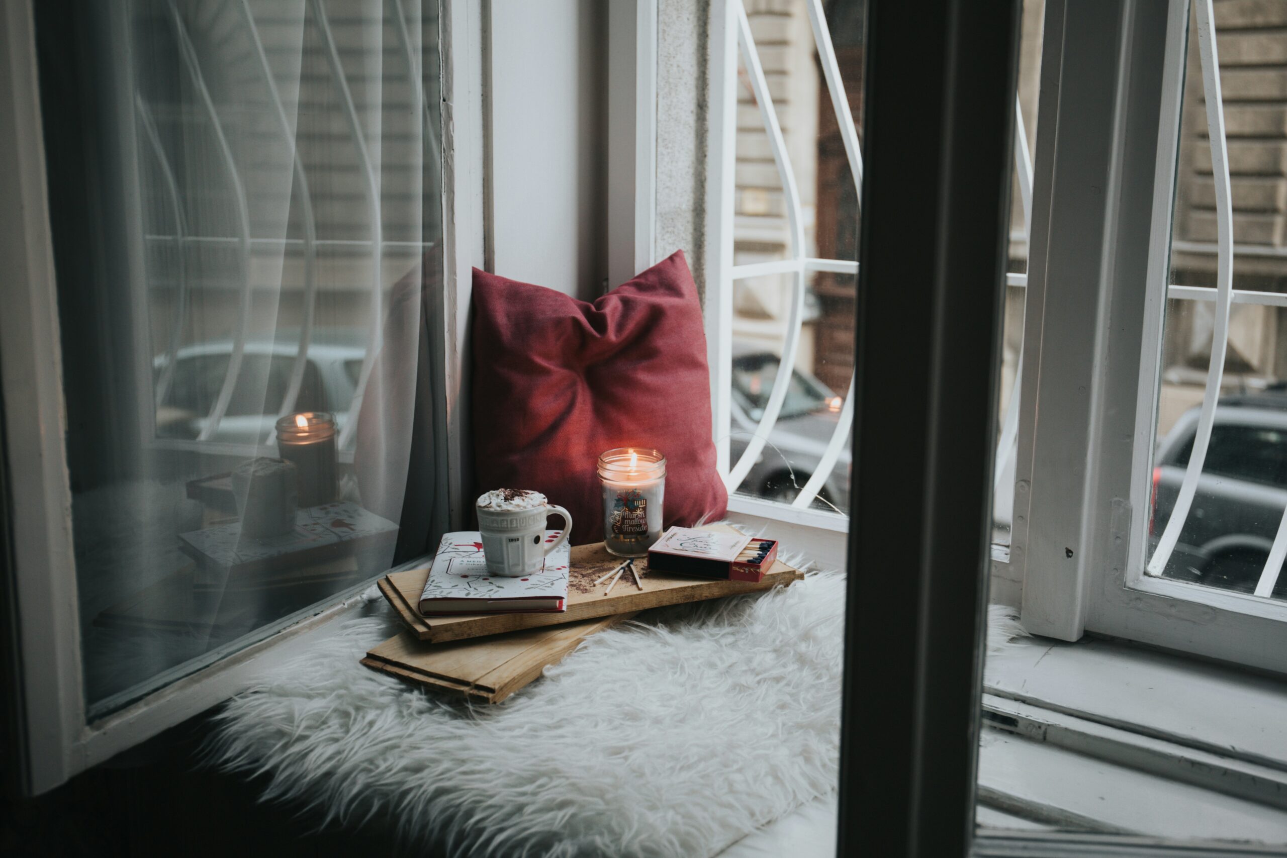 Cozy reading nook with an oversized armchair, soft blankets, and ambient lighting